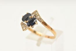 A SAPPHIRE AND DIAMOND DRESS RING, of cross over design, set with two oval shape mixed cut