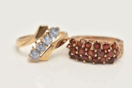 TWO 9CT GOLD GEM SET RINGS, the first of a cross over design, with an asymmetrical row of four