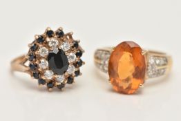 TWO 9CT GOLD GEM SET RINGS, the first set with an oval cut citrine, four claw set to the