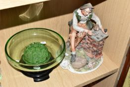 A CAPODIMONTE FIGURE AND A GREEN GLASS BOWL, the figure depicting a seated male drinking and playing