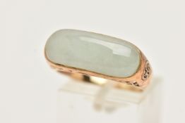 A 9CT GOLD JADE RING, designed as an elongated oval jade panel within a collet setting to the