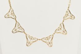 A YELLOW METAL NECKLACE, designed as a fancy link festoon style necklace with filigree detail,