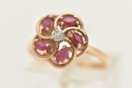 A 9CT GOLD RUBY AND DIAMOND RING, designed as a central brilliant cut diamond, surrounded by