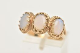 A 9CT GOLD OPAL RING, designed as three oval opal cabochons within claw settings and outer rope
