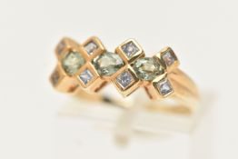 A 9CT GOLD GEM SET RING, designed as a line of three oval cut green gems, assessed as green