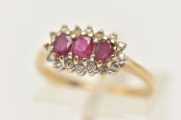 A 9CT GOLD RUBY AND DIAMOND RING, designed as three oval cut rubies within a single cut diamond