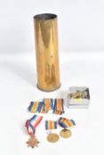 THREE WORLD WAR ONE MEDALS, FOUR CAP BADGES, AND A SHELL CASE, the medals consist of a 1914-15