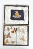 A LINED BOX WITH A SMALL COLLECTION OF CAP BADGES AND OTHERS, to include various eras of Royal