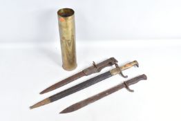 THREE NINETEENTH/TWENTIETH CENTURY BAYONETS ADN A BRASS SHELL CASE, the bayonets include an Imperial