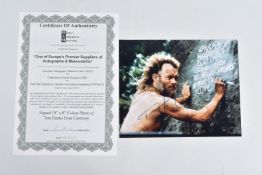 A SIGNED 10 x 8 COLOUR PROMO PHOTOGRAPH OF TOM HANKS in 'Cast Away' signed in blue ink, landscape