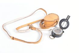 A WWII ERA COMPASS IN A TAN COLOURED LEATHER POUCH, the compass is dated 1939 and it is not