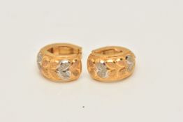 A PAIR OF ASIAN YELLOW METAL EARRINGS, each hinged ear hoop designed as foliate design textured