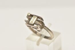 A WHITE METAL DIAMOND DRESS RING, set with a principal baguette cut diamond, measuring approximately