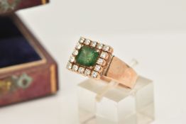 AN EMERALD AND DIAMOND CLUSTER RING, set with a square shape emerald, measuring approximately 7.09