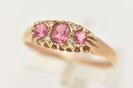 A 9CT GOLD PINK TOURMALINE AND DIAMOND RING, set with a central oval cut pink tourmaline, flanked