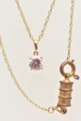 A YELLOW METAL PENDANT NECKLACE, the pendant set with a circular cut pink cubic zirconia, in a