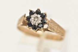 A 9CT GOLD DIAMOND AND SAPPHIRE CLUSTER RING, set with a central single cut diamond illusion set