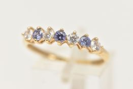 A 14CT GOLD GEM SET HALF ETERNITY RING, designed as a row of seven alternating, circular cut