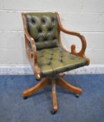 A 20TH CENTURY GREEN LEATHER BUTTONED OFFICE CHAIR (condition report: missing castor, surface marks,