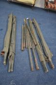FOUR FOLDING MILITARY BEDS, length 230cm, along with an arrangement of eight poles of varying length