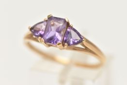 A 9CT GOLD AMETHYST RING, set with a central rectangular cut amethyst in a four claw setting,