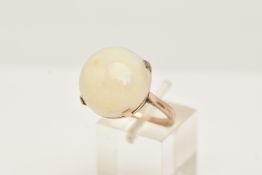 A YELLOW METAL OPAL SINGLE STONE RING, set with an opal cabochon, measuring approx 16.72 by 17.50mm,