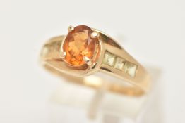 A 9CT GOLD CITRINE RING, set with a central oval cut Citrine, in a four claw setting, cross over