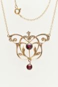 AN EDWARDIAN YELLOW METAL LAVALIER PENDANT NECKLACE, open work floral design set with a central