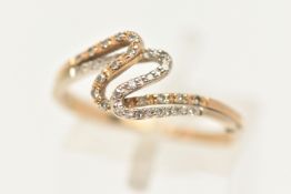 A 9CT GOLD DIAMOND RING, a thin bi-colour wave ring, prong set with single cut diamonds,