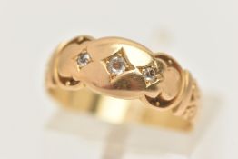 A YELLOW METAL DIAMOND RING, set with three small old cut diamonds, to the scrolling shoulders and