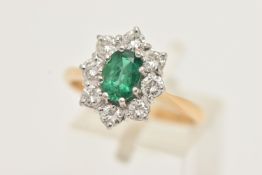 AN 18CT GOLD EMERALD AND DIAMOND RING, designed and an oval cut emerald, approximate
