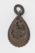 A VICTORIAN VULCANITE PENDANT, a large tear drop form pendant with graduated beading surround, bunch