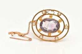 A YELLOW METAL AMETHYST AND SEED PEARL BROOCH, set with a central oval cut amethyst, collet set