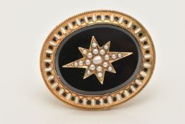 A YELLOW METAL ONYX, SPLIT PEARL AND ENAMEL MEMORIAL BROOCH, of an oval form set with a central onyx