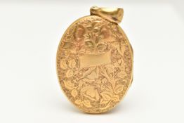 A LARGE YELLOW METAL OVAL LOCKET, detailed with a floral and ivy leaf pattern with vacant cartouche,