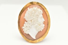 A YELLOW METAL CAMEO BROOCH, of an oval form, carved shell cameo depicting a Grecian man, collet set