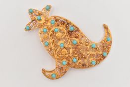 A YELLOW METAL FILIGREE BROOCH, of Middle Eastern design, set with blue paste cabochon accents to