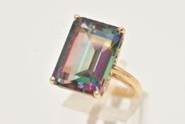 A YELLOW METAL LARGE MYSTIC TOPAZ DRESS RING, set with a large rectangular cut mystic topaz,