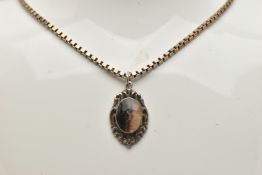 A BLUE JOHN FLOURITE PENDANT WITH SILVER CHAIN, the white metal scrolling detailed pendant set
