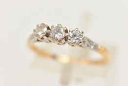 A WHITE AND YELLOW METAL DIAMOND THREE STONE RING, set with slightly graduating round brilliant