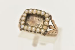 A YELLOW METAL SPLIT PEARL MOURNING RING, of a rectangular form with vacant compartment missing