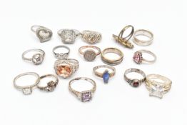 A BAG OF WHITE METAL RINGS, various designs and styles, some set with cubic zirconia stones,