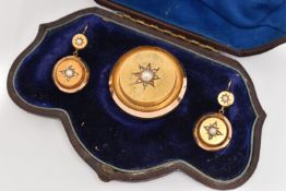 A CASED YELLOW METAL DIAMOND BROOCH AND EARRING SUITE, the brooch of a polished circular form star