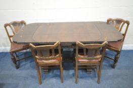 A 20TH CENTURY OAK SIX PIECE LOUNGE SUITE, comprising a draw leaf dining table, with a carved apron,