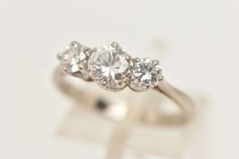 A WHITE AND YELLOW METAL DIAMOND THREE STONE RING, set with graduating round brilliant cut diamonds,