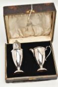 A GEORGE V CASED MILK JUG AND SUGAR CASTER SET, plain polished design with C scroll handle,