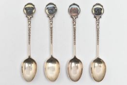 FOUR SILVER TEASPOONS, each with a painted round terminal depicting dogs, the scrolling stems and