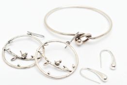 A SILVER BANGLE, AND TWO PAIRS OF WHITE METAL EARRINGS, the bangle with lovers knot toggle style