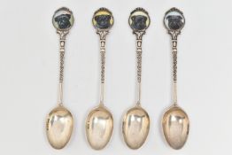 FOUR SILVER TEASPOONS, each with a painted round terminal depicting dogs, the scrolling stems and
