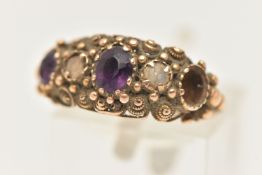 A YELLOW METAL GEM SET RING, AF set with two oval cut amethysts (one missing) and a single split